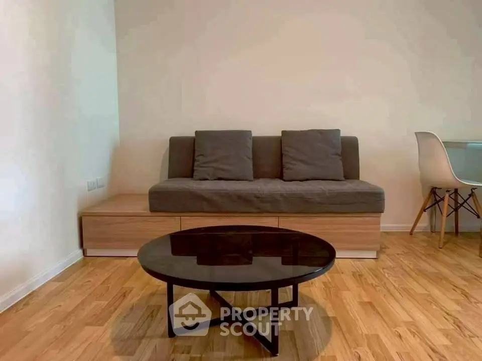 Modern living room with stylish sofa and sleek coffee table on wooden flooring.