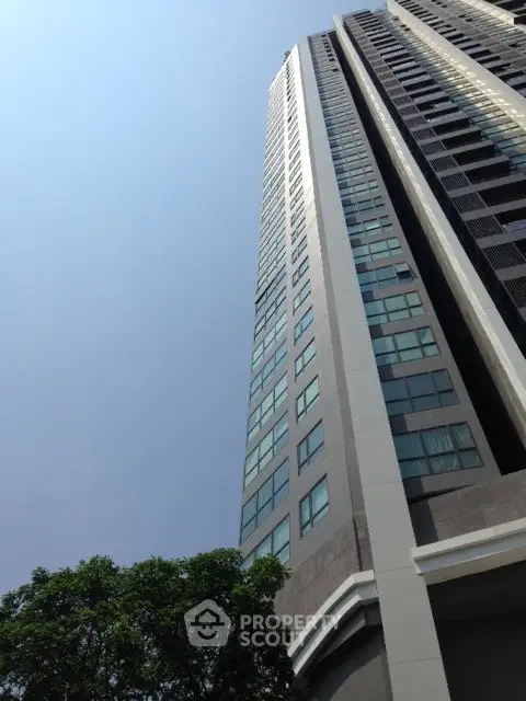 Stunning high-rise building with modern architecture and expansive windows in urban setting.
