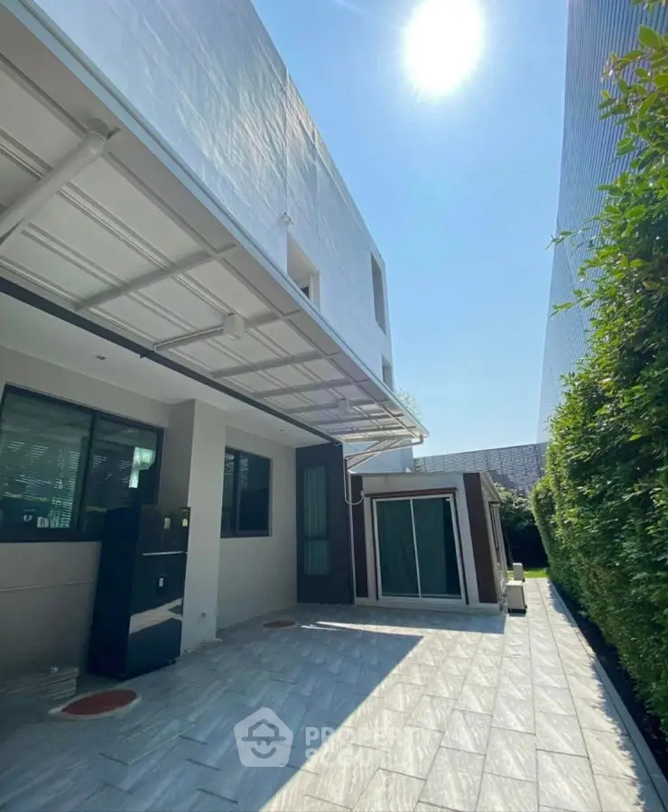 Modern building exterior with sleek design and sunny outdoor space