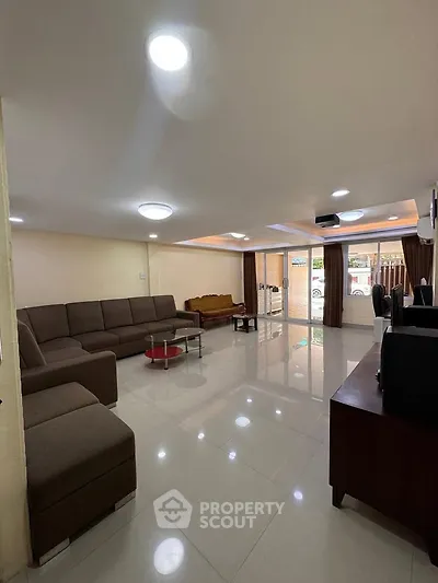 Spacious living room with modern furniture and large windows for natural light.