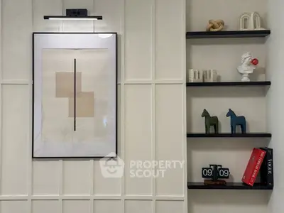 Stylish modern interior with framed art and decorative shelves in a chic living space.