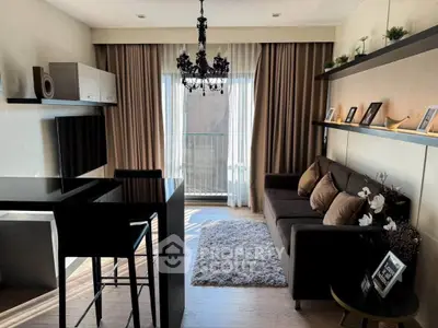 Stylish modern living room with elegant chandelier and cozy seating area, perfect for relaxation.