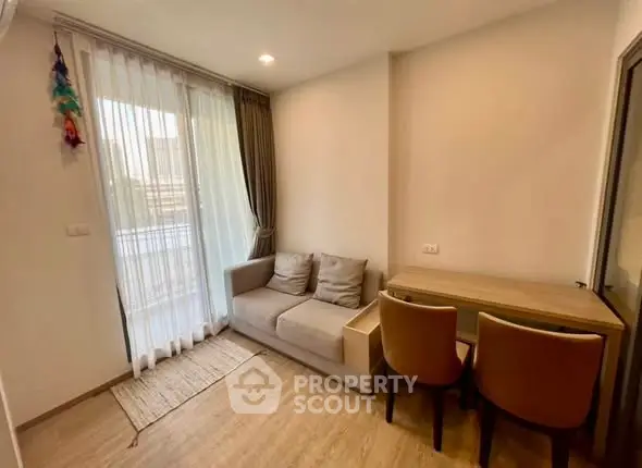 Cozy living room with natural light and modern furniture in a stylish apartment.