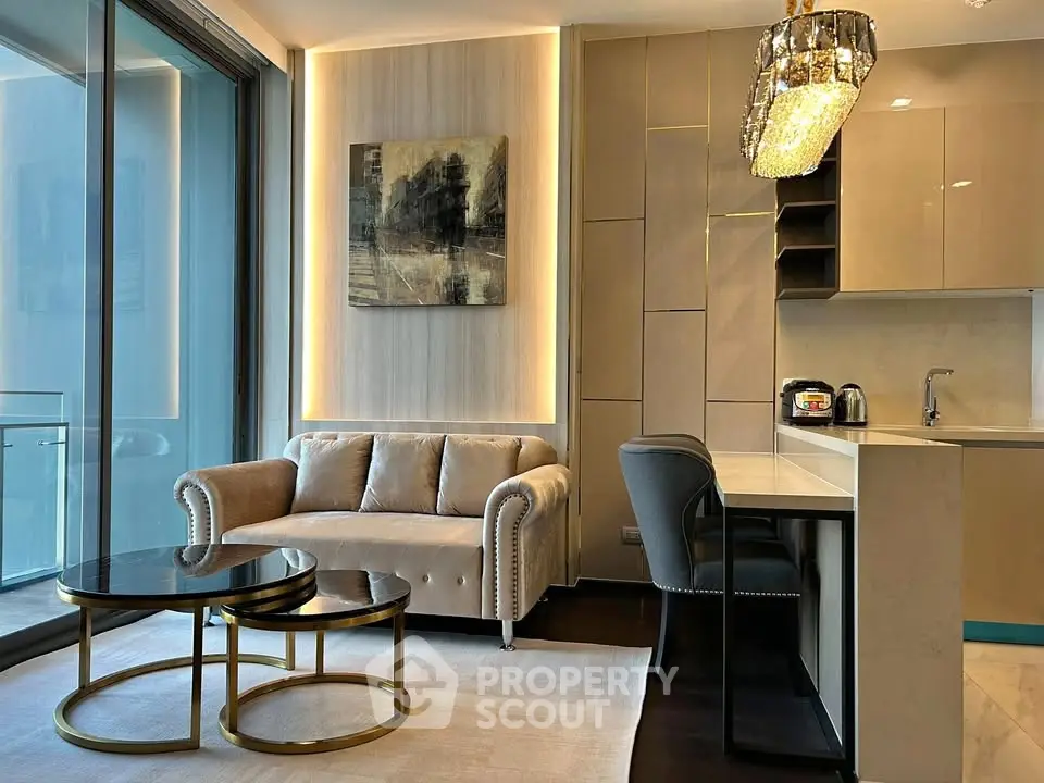 Luxurious modern living room with elegant decor and open kitchen layout, featuring a plush sofa and stylish lighting.