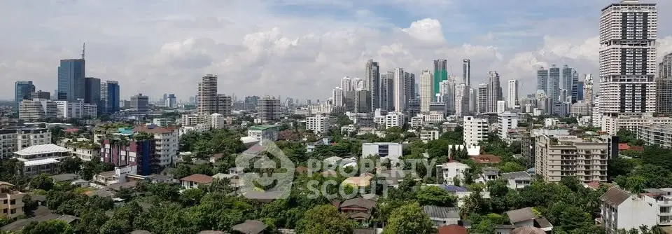 Stunning panoramic cityscape view showcasing a vibrant urban skyline with lush greenery.