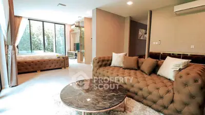 Luxurious open living room with elegant brown sofa and marble coffee table