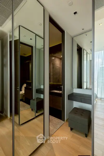 Luxurious modern bedroom with mirrored closet and elegant wooden flooring