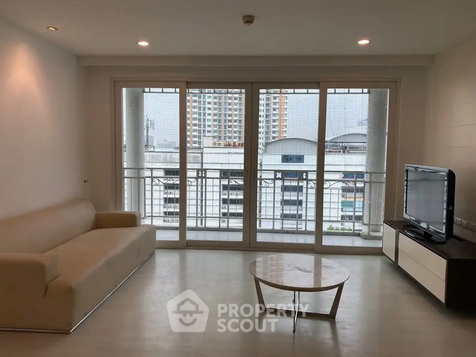 Spacious living room with modern sofa and city view balcony
