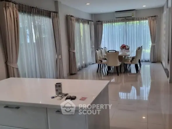 Elegant dining room with large windows and modern decor