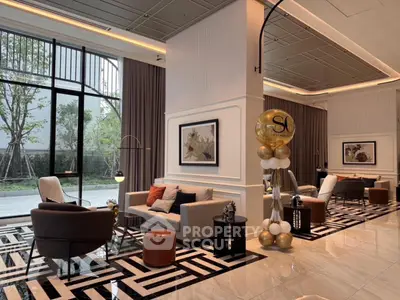 Luxurious modern living room with elegant decor and large windows overlooking greenery.