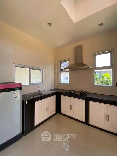 Modern kitchen with sleek black countertops and gas stove