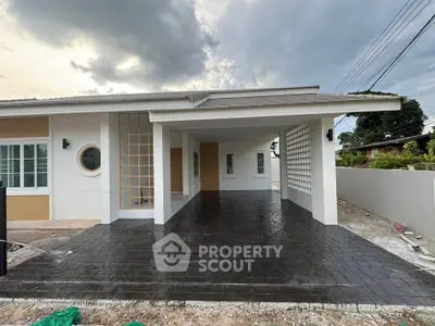 Modern single-story house with spacious carport and contemporary design.