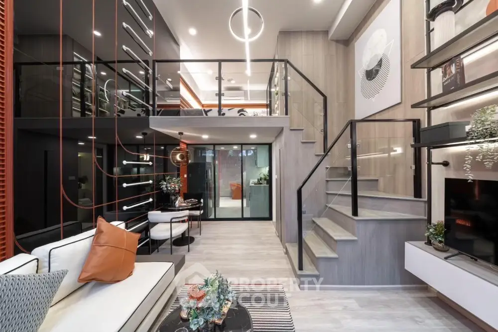 Modern duplex living room with stylish decor and mezzanine level, featuring sleek design and contemporary furnishings.