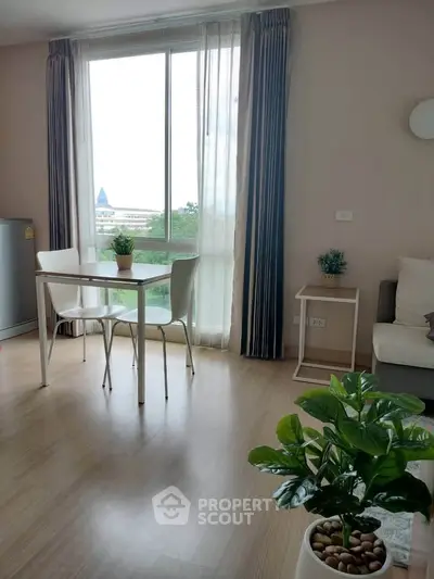 Bright and airy living room with large window and modern decor