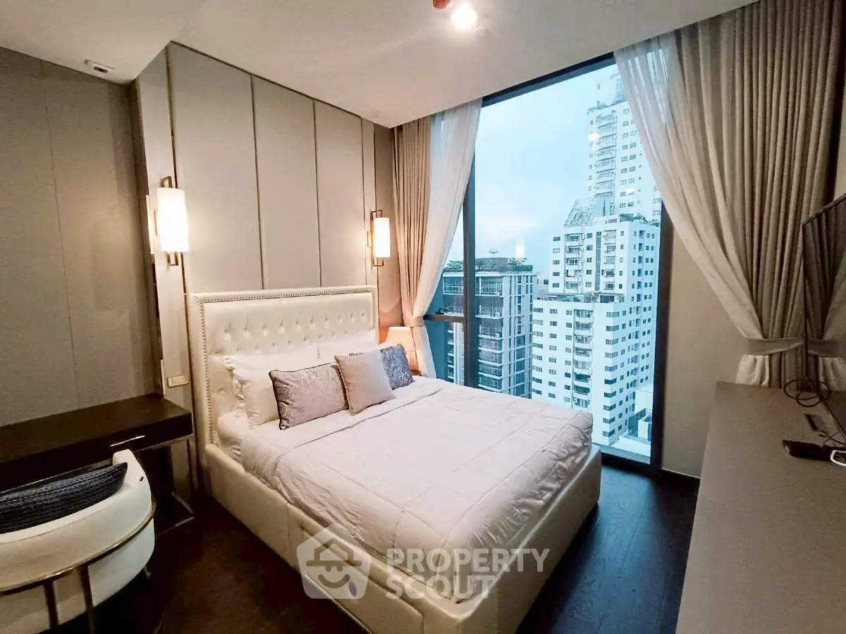 Luxurious bedroom with city view in modern high-rise apartment