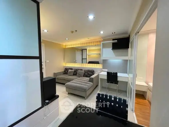 Modern living room with stylish furniture and ambient lighting in a contemporary apartment.