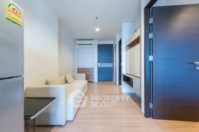 Modern living room with sleek design and neutral tones, featuring a comfortable sofa and stylish wooden flooring.
