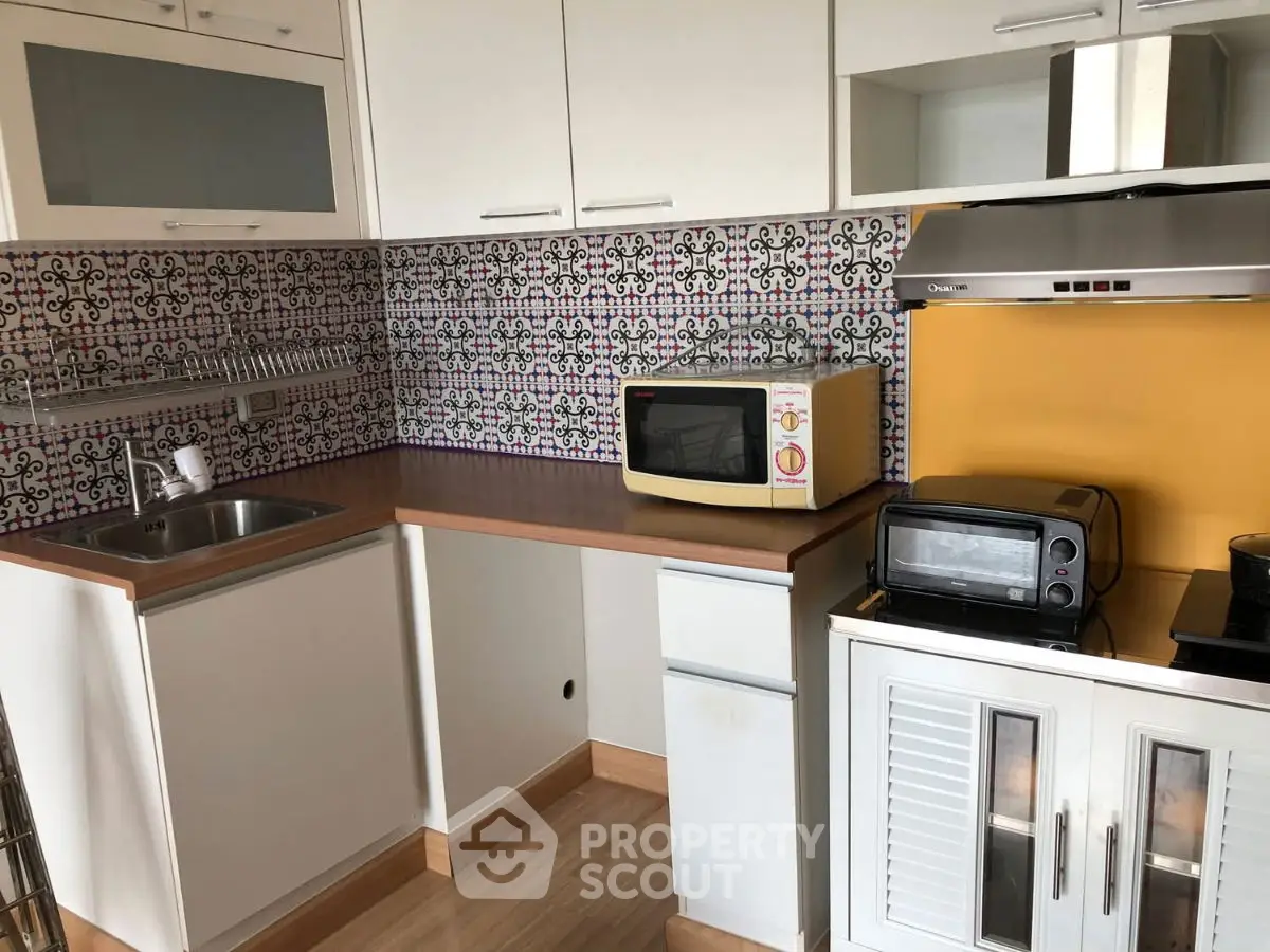 Charming kitchen with colorful backsplash and modern appliances