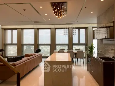 Luxurious open-plan living room with stunning city view and modern kitchen.