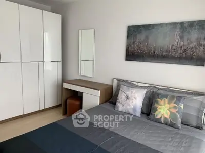 Modern bedroom with sleek wardrobe and stylish decor in a contemporary apartment.
