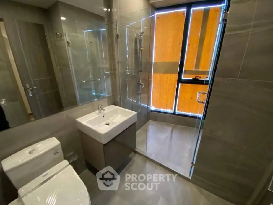 Modern bathroom with sleek fixtures and glass shower enclosure