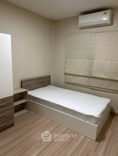 Cozy minimalist bedroom with single bed and air conditioning