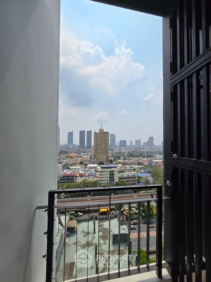 Stunning cityscape view from a high-rise balcony with modern railing.