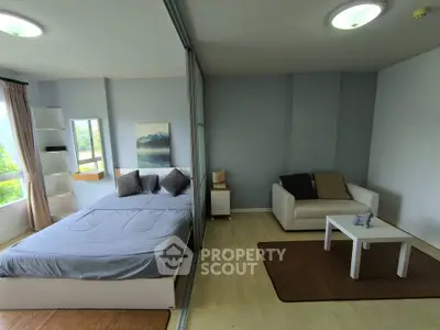 Modern studio apartment with cozy bed and stylish living area