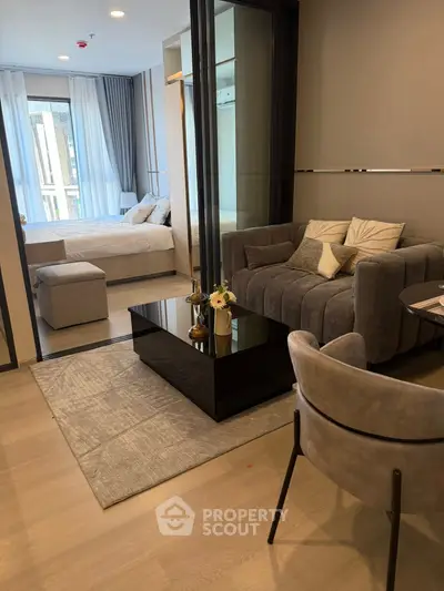 Modern living room with cozy seating and elegant decor in a stylish apartment.