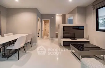 Modern living room with elegant dining area and sleek furnishings