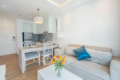 Bright modern living room with open kitchen, stylish decor, and cozy seating area.