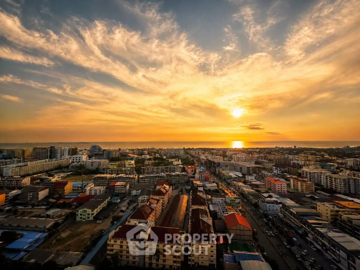 Stunning sunset view over a vibrant cityscape with a mix of residential and commercial buildings.