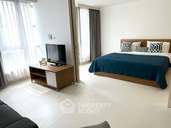 Spacious modern bedroom with natural light and stylish decor