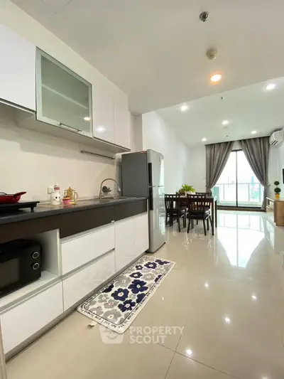 Modern kitchen and dining area with sleek design and natural light