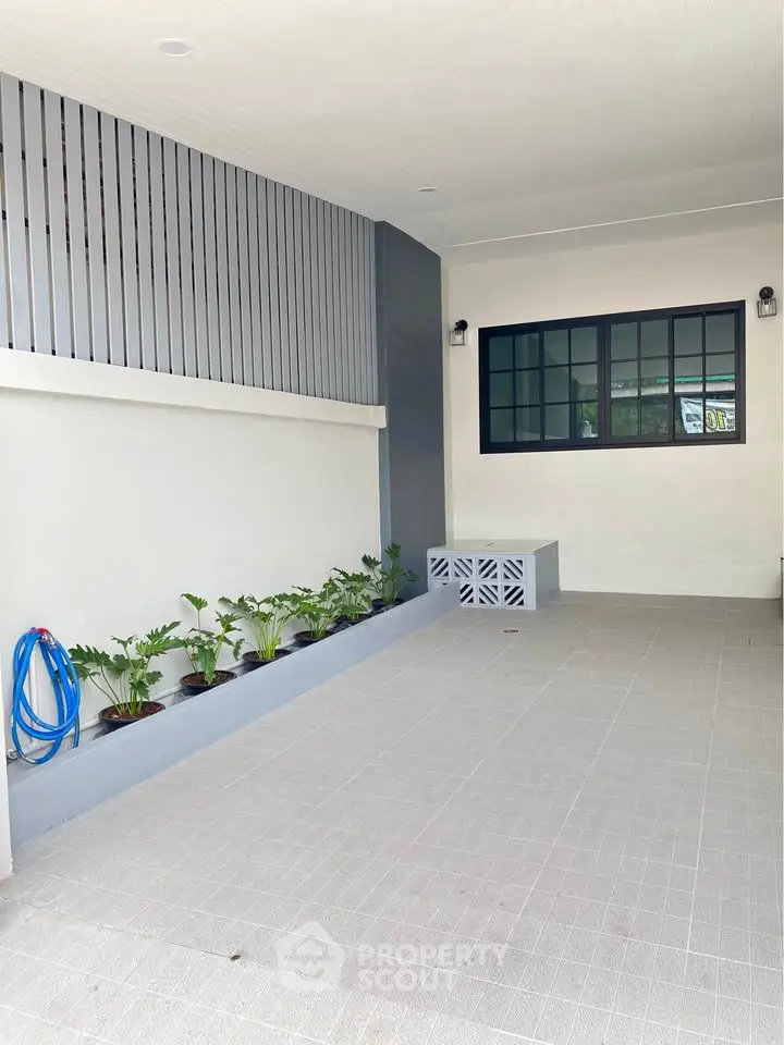 Spacious modern parking area with sleek design and potted plants