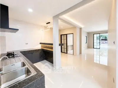 Modern open-layout kitchen and living room with sleek design and natural light