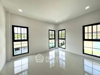 Bright corner unit with large windows and glossy tiled floors, offering ample natural light and modern design.