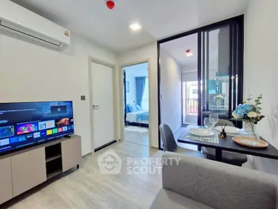 Modern living room with open layout, featuring a cozy dining area and stylish decor.