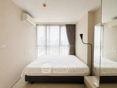 Modern bedroom with large window and city view, featuring minimalist decor and air conditioning.