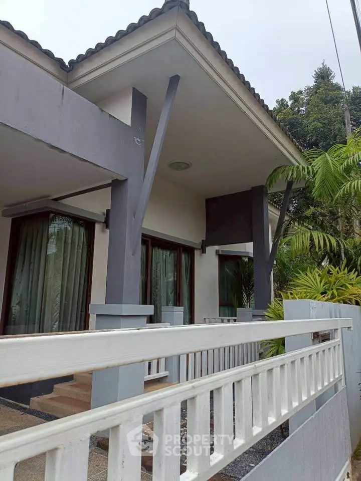 Charming modern house exterior with lush greenery and stylish architecture.