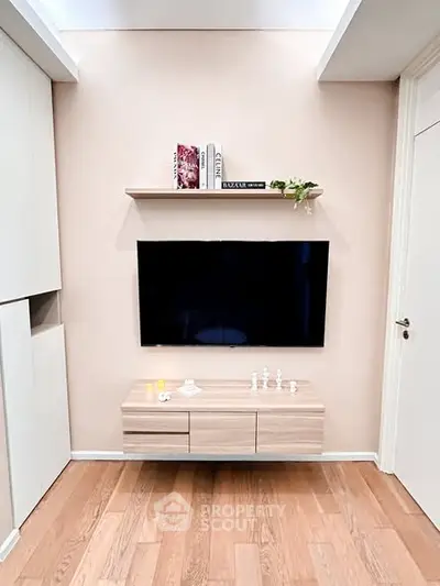Modern living room with wall-mounted TV and sleek wooden cabinet