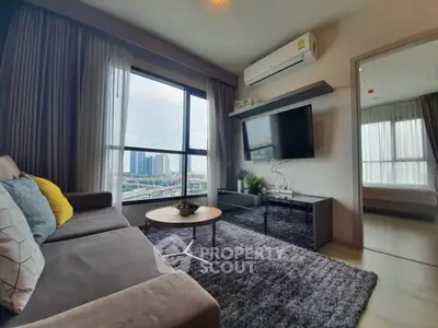 Modern living room with city view, cozy sofa, and wall-mounted TV in a stylish apartment.