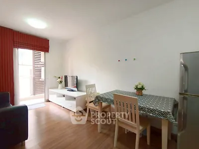 Cozy living room with dining area and balcony access in modern apartment.