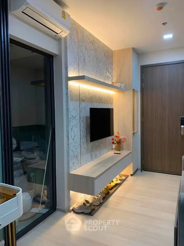 Modern living room with sleek TV unit and stylish decor in a contemporary apartment.