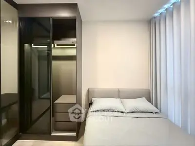 Modern bedroom with sleek wardrobe and cozy bed, perfect for urban living.