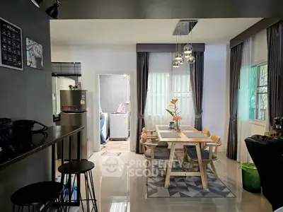 Modern dining area with stylish decor and adjacent laundry space in a cozy home setting.