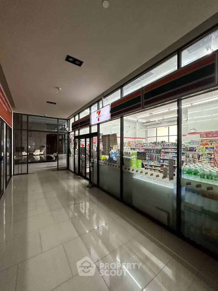 Spacious commercial retail space with glass storefront and modern interior lighting.