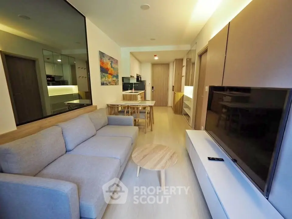 Modern living room with sleek furniture and open layout in a stylish apartment.