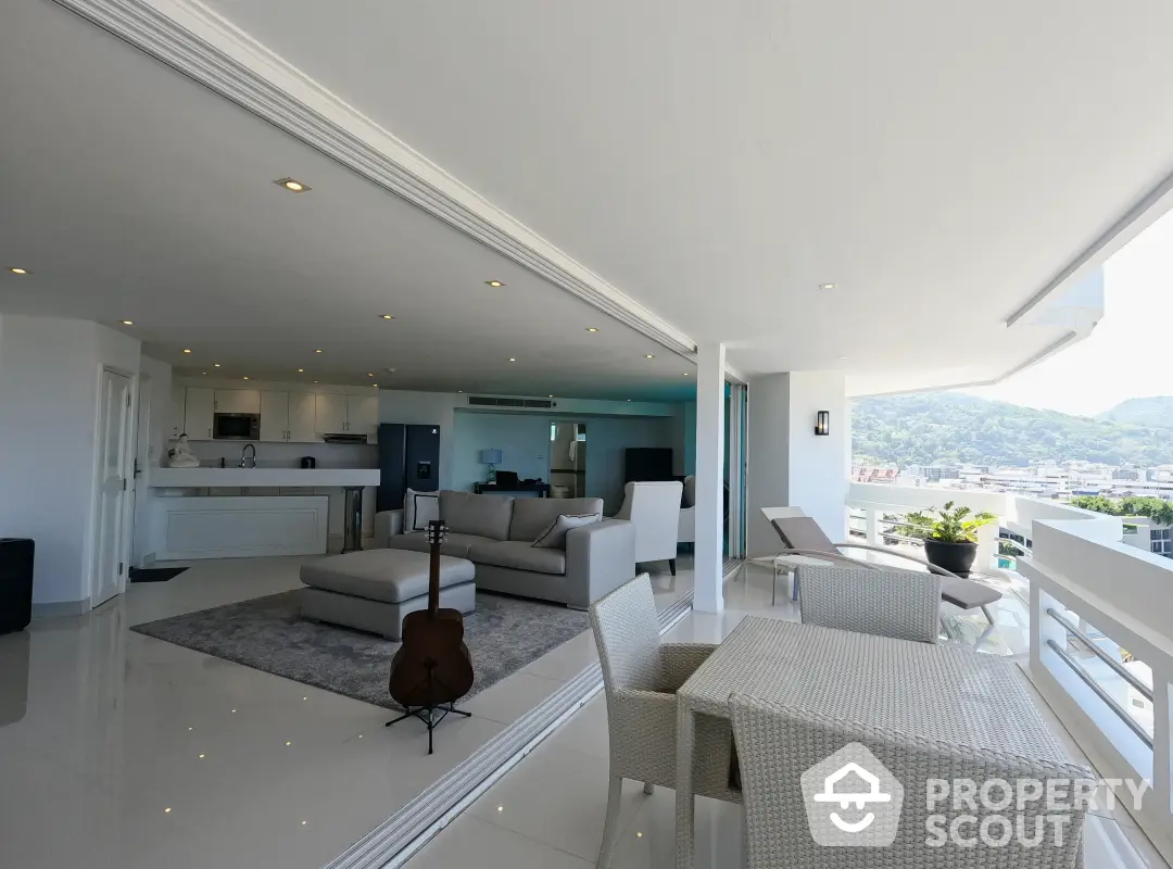 Spacious modern living area seamlessly connects to a large balcony with stunning views, featuring high-end finishes and ample natural light.