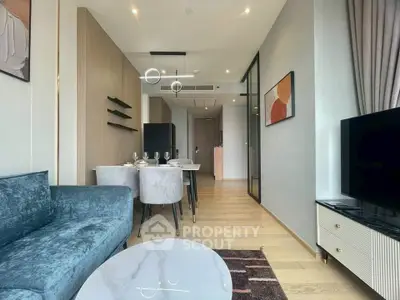 Modern living room with elegant decor and dining area in open layout apartment.